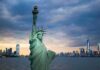 Long-Lost Name Revealed — Genealogy Breakthrough Rocks Ground Zero Statue of Liberty with city skyline at dusk