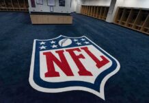DHS Uses Dawkins – League Hits Back NFL logo on the floor of an empty locker room