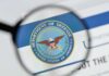 White House Meeting, Then Boom—He’s Out magnifying glass focusing on U.S. Department of Defense seal
