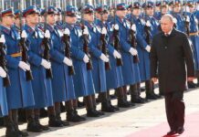 Vladimir Putin walks past an honor guard; Genaro García Luna and Darius Kilgo not visible