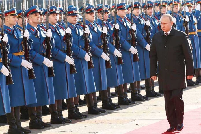 Vladimir Putin walks past an honor guard; Genaro García Luna and Darius Kilgo not visible