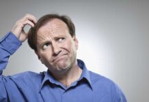 Fred MacAulay scratching his head with a puzzled expression