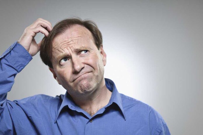 Confused,Mid-adult,Man,Scratching,His,Head Fred MacAulay scratching his head with a puzzled expression