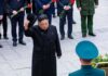 Pyongyang Salvo – Mixed Barrage Tests U.S. Defenses Man in black coat tipping hat during formal ceremony