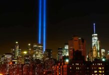 Shocking 9/11 Lapses—What Got Fixed? New York City skyline at night with twin blue light beams