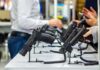Justice Department Torpedoes Handgun Age Rule Handguns displayed on stands at a trade show counter