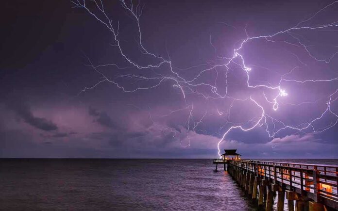 Lightning over a pier at night