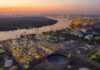 Scarier Than Gas Prices – SPR Reality Check Industrial oil refinery complex beside a river at dusk