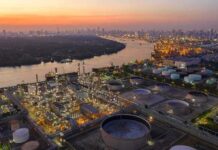 Scarier Than Gas Prices – SPR Reality Check Industrial oil refinery complex beside a river at dusk