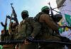 Hamas Gun Stash Exposed In Germany armed masked men in military gear holding rifles