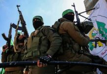 Hamas Gun Stash Exposed In Germany armed masked men in military gear holding rifles