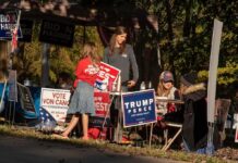 MAGA Muscle Tested — South Carolina Erupts People at a campaign booth with political signs outdoors