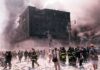 First responders amid debris near a heavily damaged building
