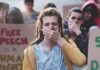 Stunning Shift: One-Third OK Violence Protester covering mouth during rally