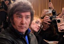 Global Body ROASTED – UN “Parasites” Exposed Man surrounded by reporters with cameras and phones