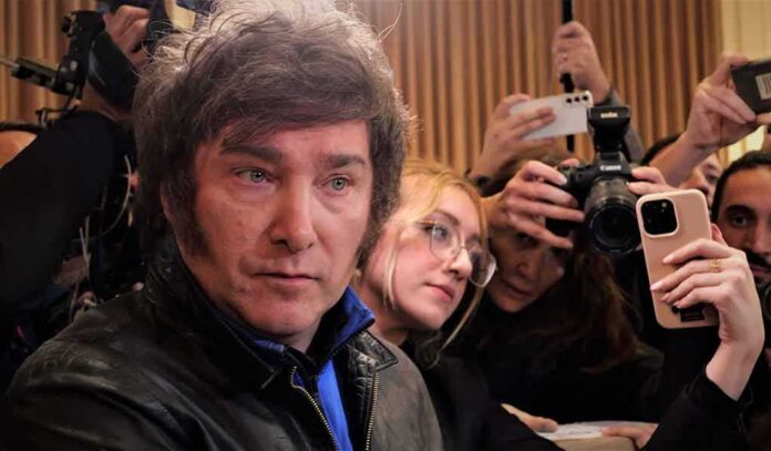 shutterstock_2349157881 Man surrounded by reporters with cameras and phones