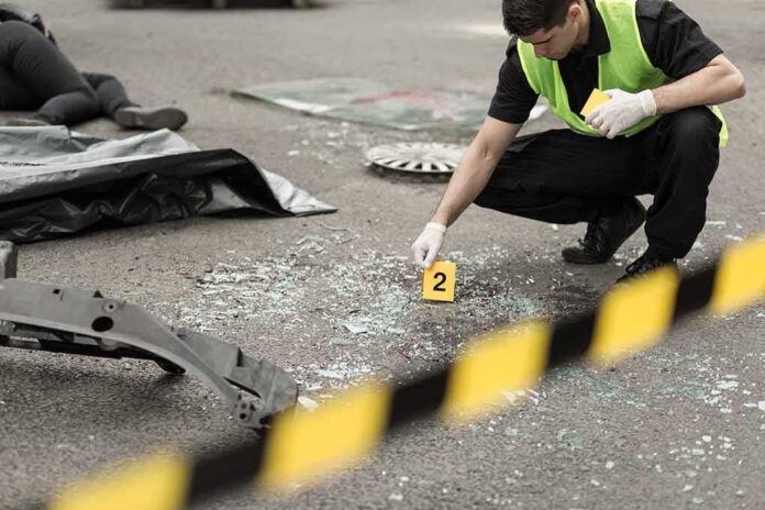 shutterstock_301329224 Forensic investigator marking evidence at crash scene