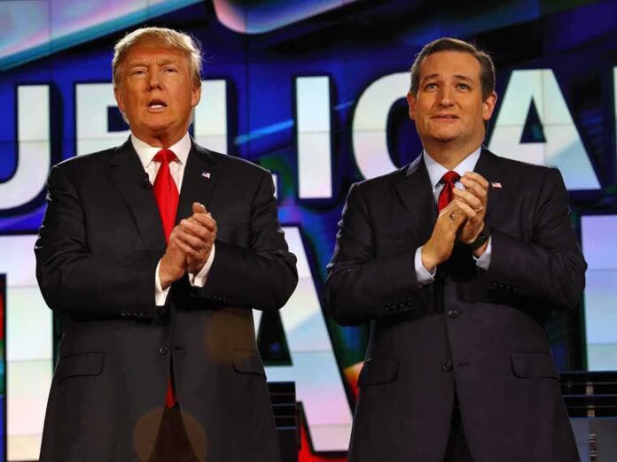 two men in suits clapping on a brightly lit stage