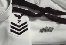 Navy dress uniform with rank chevrons and insignia