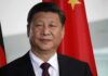 Xi Jinping portrait with flags in the background