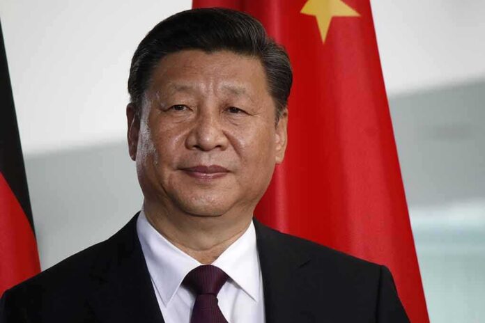shutterstock_677148799 Xi Jinping portrait with flags in the background