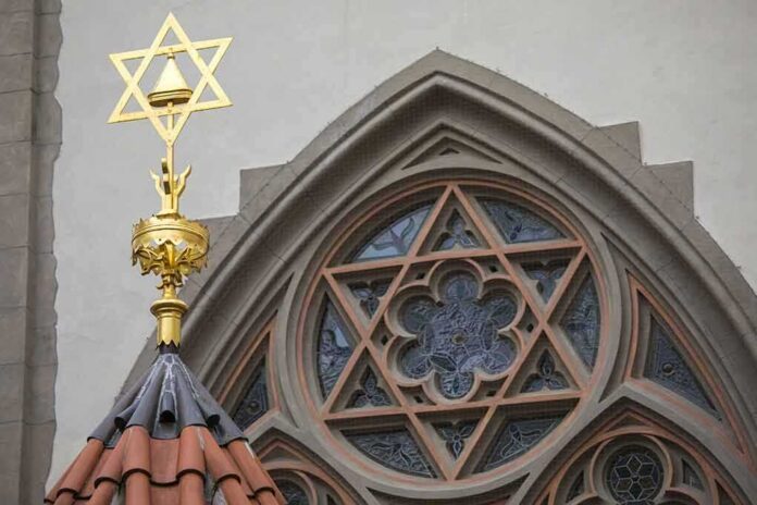 Star of David atop synagogue roof with stained glass window