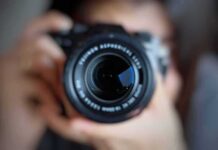 Virginia’s ‘Most Diverse’ Claim – Photo Op Explodes Into DEI Fight camera lens close-up held by a person