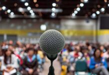 White Privilege Claim – One Question Shuts It Down Microphone on stage facing a blurred audience