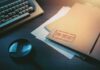 Top secret file folder on desk with magnifying glass and typewriter