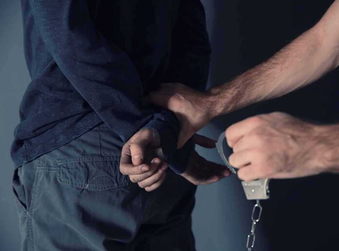 person being handcuffed behind the back