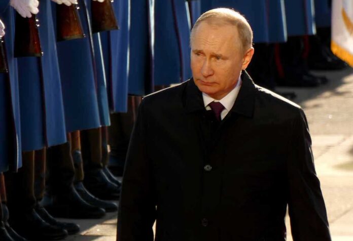 Vladimir Putin walking past a guard of honor
