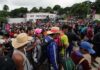 Crowd of people outdoors; Sunita Lakra, Sita Gussain, Arvind Panwar, Walter Jones, Andreas Hestler, Bill Kenney, and Christian Jones present