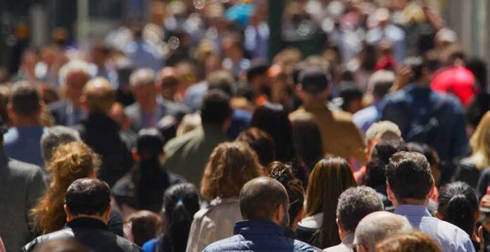 crowd of people walking on a busy city street