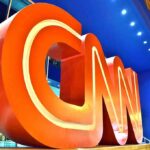 Large red CNN logo sculpture at building entrance