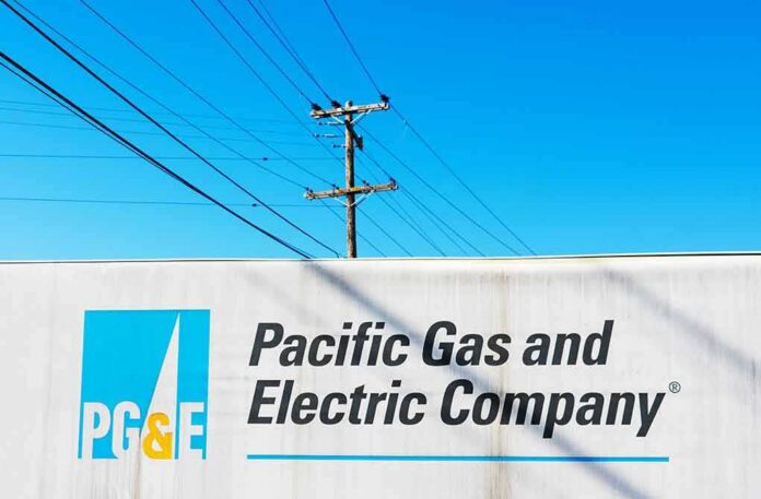 shutterstock_1555882880 Pacific Gas and Electric Company sign with utility pole and power lines