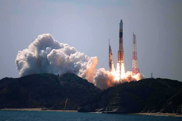 Rocket lifts off from coastal launch site with smoke and flames