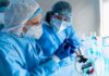Quarantines Trigger Plague Whispers Scientists in protective gear working with a syringe in a laboratory