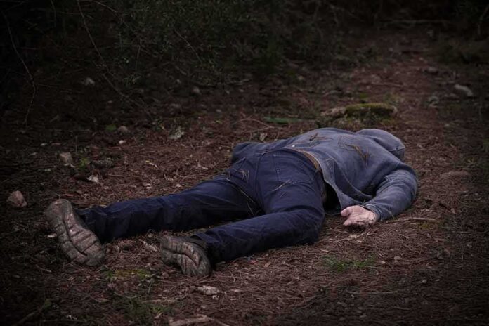 shutterstock_1854713230 person lying face down on a forest path