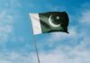 Coerced Conversion? Boy Disappears, Cops Balk Pakistan flag waving against a blue sky