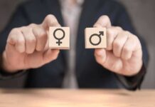 Title IX Knife-Edge: Court Opens The Fight Hands holding wooden blocks with female and male symbols