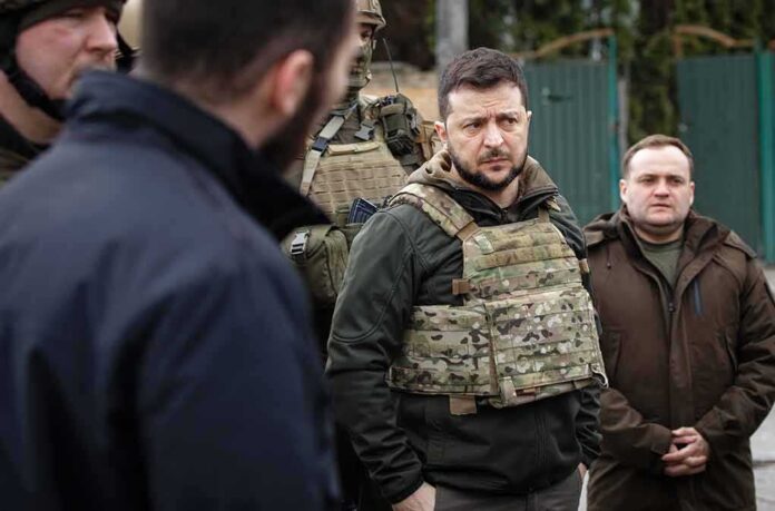 shutterstock_2148138423 man in tactical vest standing with group outdoors
