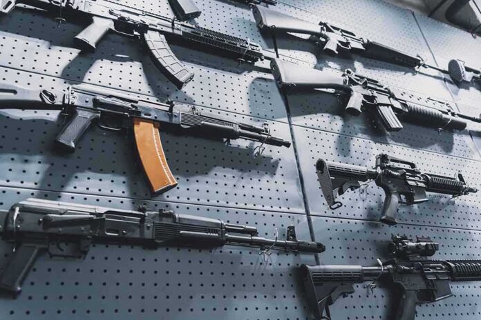 Assault rifles displayed on a perforated wall