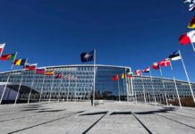 Kaliningrad Ultimatum – Blockade Talk Triggers Doomsday Warnings NATO headquarters with member flags in front under a clear blue sky
