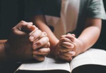 Bible Muzzle EXPOSED – Costly Apology Adult and child hands clasped in prayer over an open book