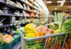 Backlash Explodes Over Israel-Grocery Ad shopping cart filled with fresh produce in a grocery store aisle