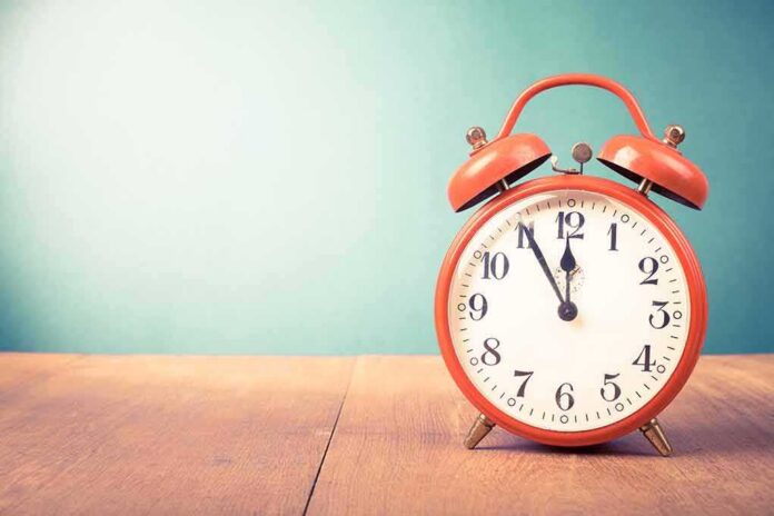 red retro alarm clock on wooden table