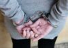 person in handcuffs with hands behind back