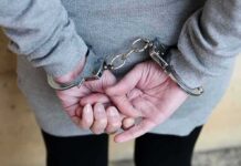 Detained Without Bond? Big Test Ahead person in handcuffs with hands behind back