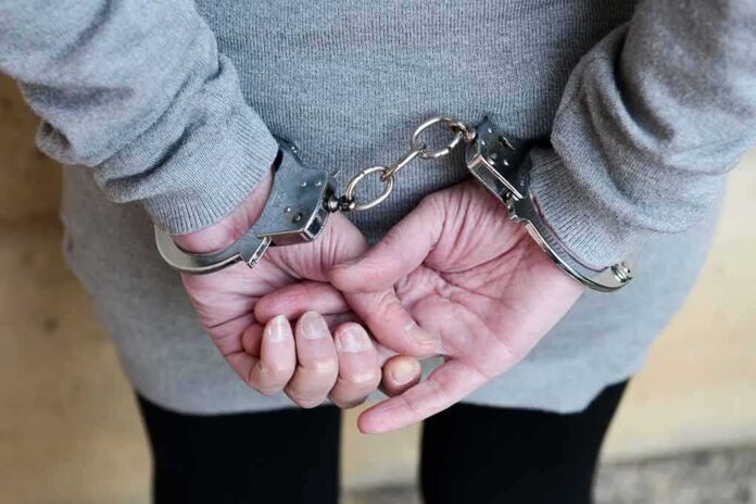 person in handcuffs with hands behind back