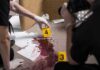 Racist Terror Rampage Shocks Paris forensic investigators documenting a bloodstained crime scene